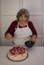 older woman making a cake Royalty Free Stock Photo