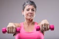 Older woman working out with a pair of dumbbells Royalty Free Stock Photo