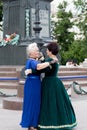 The older women spend their leisure time dancing in the square