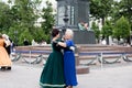 The older women spend their leisure time dancing in the square