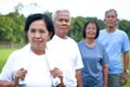 Older women standing in front of the back of the group. Exercise in the garden.