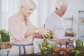 Older woman tossing a salad Royalty Free Stock Photo