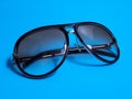 dark brown vintage sunglass isolated on light blue background