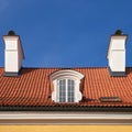 Oldgarret roof with window and chimneys. Retro attic window and fireplace chimneys,