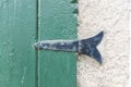 Oldie hinge in green wooden windows textured wall