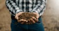 Oldman farmer holding soil in cupped hands