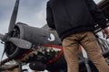 Oldschool pilot in the bomber jacket posing near the aircraft Royalty Free Stock Photo