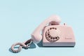 Oldschool pink telephone on a blue background Royalty Free Stock Photo