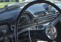 Oldsmoibile Black Dashboard Close-up with Steering Wheel and Radio