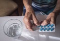 Oldster taking daily medication dose at home Royalty Free Stock Photo