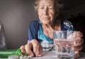 Oldster taking daily medication dose at home Royalty Free Stock Photo