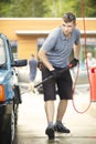 Oldtimer car enthusiast washing his small car by water Royalty Free Stock Photo