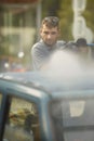 Oldtimer car enthusiast washing his small car by water Royalty Free Stock Photo