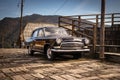 Oldtimer car Volga GAZ-21 built in a soviet Russia in traditional retro village