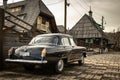 Oldtimer car Volga GAZ-21 built in a soviet Russia in traditional retro village