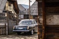 Oldtimer car Volga GAZ-21 built in a soviet Russia in traditional retro village