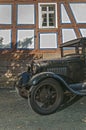 Oldtimer in front of half timbered house Royalty Free Stock Photo