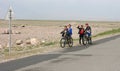 Olgii, Mongolia - July 28, 2019: mongolian boys on bicycles in the steppe of Mongolia