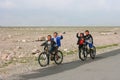 Olgii, Mongolia - July 28, 2019: mongolian boys on bicycles in the steppe of Mongolia