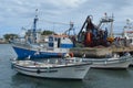 The crew of a purse seiner collects its nets in Olhao fishing harbour, Algarve, Southern Portugal