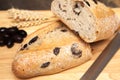 A whole freshly baked olive bread with loves and wheat Royalty Free Stock Photo