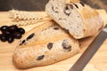 A whole freshly baked olive bread with loves and wheat Royalty Free Stock Photo