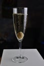 Olive in a champagne glass covered with bubbles on a dark background Royalty Free Stock Photo