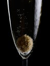 Olive in a champagne glass covered in bubbles. Isolated on a black background Royalty Free Stock Photo