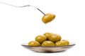 Olive with drop on fork, plate of olives