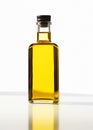 Olive fresh extra virgin oil in a glass bottle on white background.