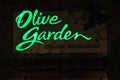 An Olive Garden restaurant sign is illuminated at night