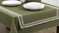 Olive green tablecloth lace trim dining room table setting Royalty Free Stock Photo
