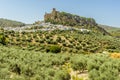 Olive groves lead up to the hilltop fortress in the town of Montefrio, Spain