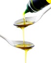 Olive oil being poured into a spoon Royalty Free Stock Photo