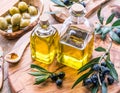 Olive oil and berries are on the olive wooden tray. Royalty Free Stock Photo