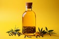 Olive oil bottle with a blend of spices set against a yellow background Royalty Free Stock Photo