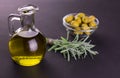 Olive oil in a bottle and fresh rosemary on a dark background. Royalty Free Stock Photo