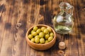 Olive oil bottle and olives on wooden background with copy space Royalty Free Stock Photo