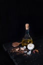 Olive oil bottle, garlic and seeds in dark rustic background