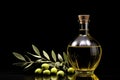 olive oil bottle, olives and olive branch on a black background.