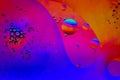 Olive oil bubbles in water with florescent colors Royalty Free Stock Photo