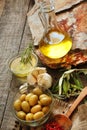 Olive oil in a bowl and carafe on vintage wooden boards.