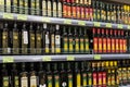 Olive oil of different brands in a grocery store. Large assortment of high quality healthy cooking olive oil. Minsk, Belarus, 2022