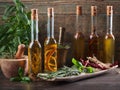 Olive oil with different spices and herbs on a wooden table. Royalty Free Stock Photo