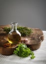 Olive oil with fresh spices on a wood board