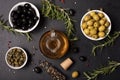 olive oil in a glass bottle with olives, herbs and spices Royalty Free Stock Photo