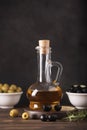 olive oil in a glass bottle with olives, herbs and spices Royalty Free Stock Photo