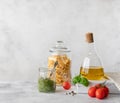 Olive oil in a glass bottle, treccia pasta in a jar and basil pesto sauce Royalty Free Stock Photo
