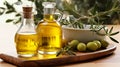 Olive oil in glass transparent bottles. Organic olive oil on a white wooden table.