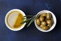 Olive oil and green olives on a blue background. Royalty Free Stock Photo